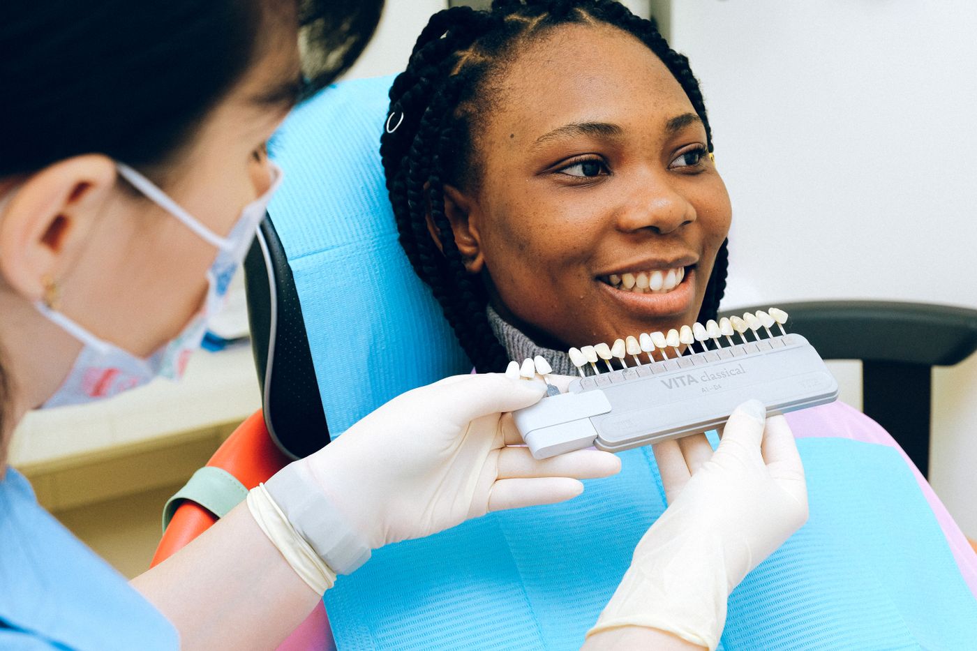 Smiling patient speaking with a dental professional in a bright clinic